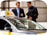 Image of an instructor and adviser, with an AA Ford Focus training car