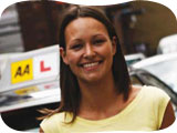 Image of a happy AA learner in front of her tuition car