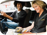 Image of an AA driving instructor in a car with her pupil
