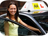 Image of a happy AA pupil in front of her AA tuition car