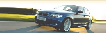 Get a quote for short-term car insurance (image: red car on the bend of a road) - link opens a new window
