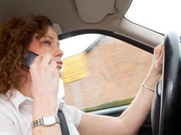 Lady driving while on a mobile phone