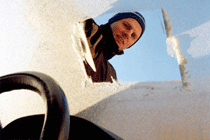 Man clearing windscreen
