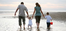 family walking along a beach
