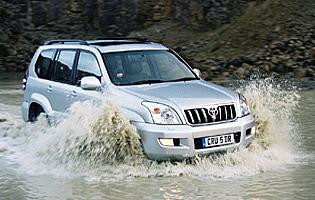 picture of Toyota land cruiser driving through water splash