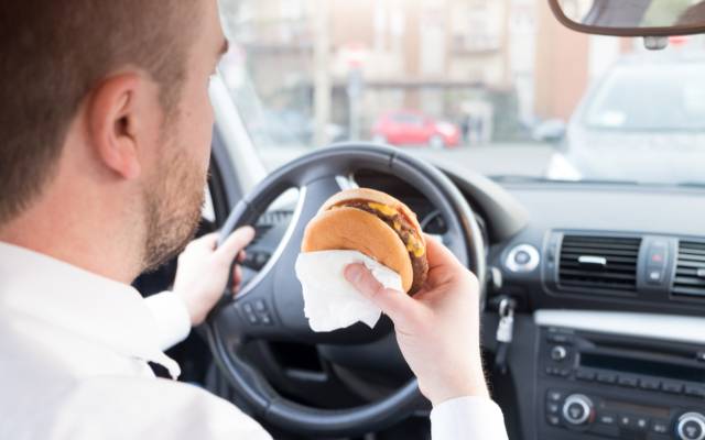Man eating while driving - is it illegal?