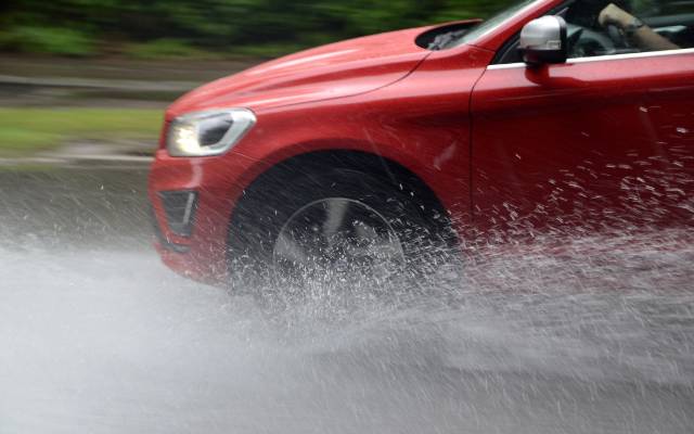 Car aquaplaning in puddle of water