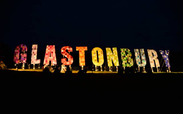 Glastonbury festival sign lit up at night