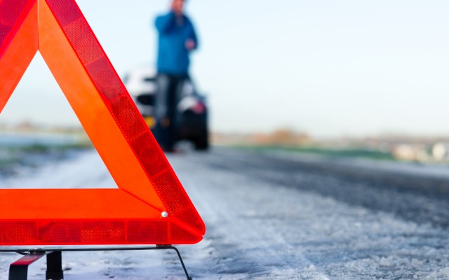 car broken down in winter with warning triangle