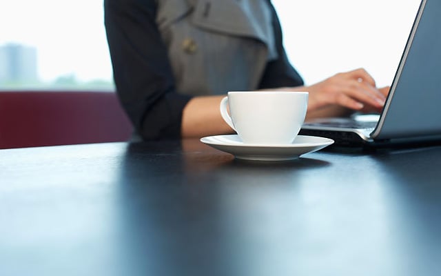 Woman using laptop coffee