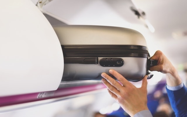 Hand luggage in overhead locker