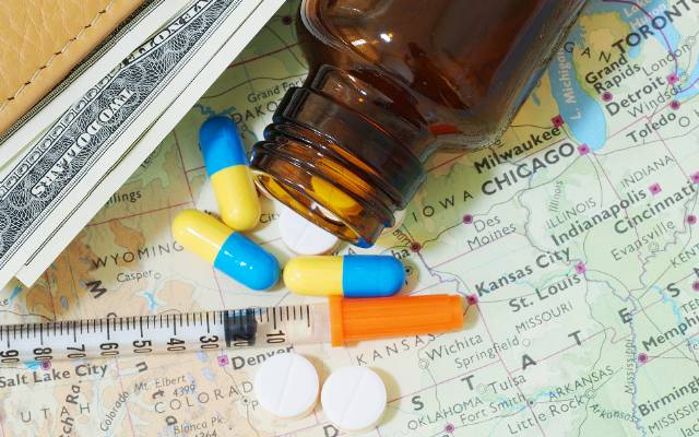 medicines on top of a travel map of the USA