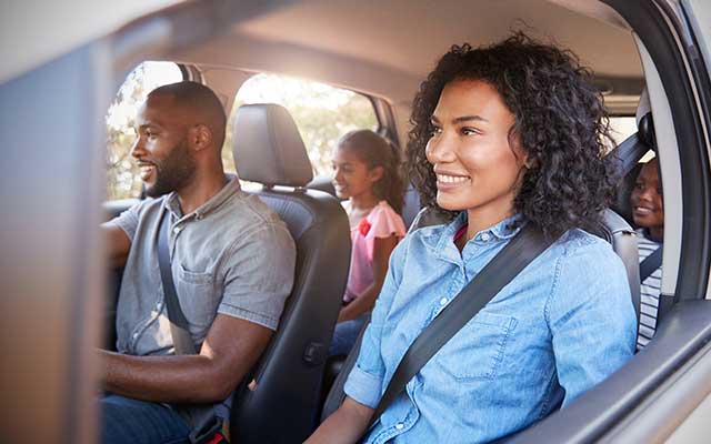 Family in car on road trip