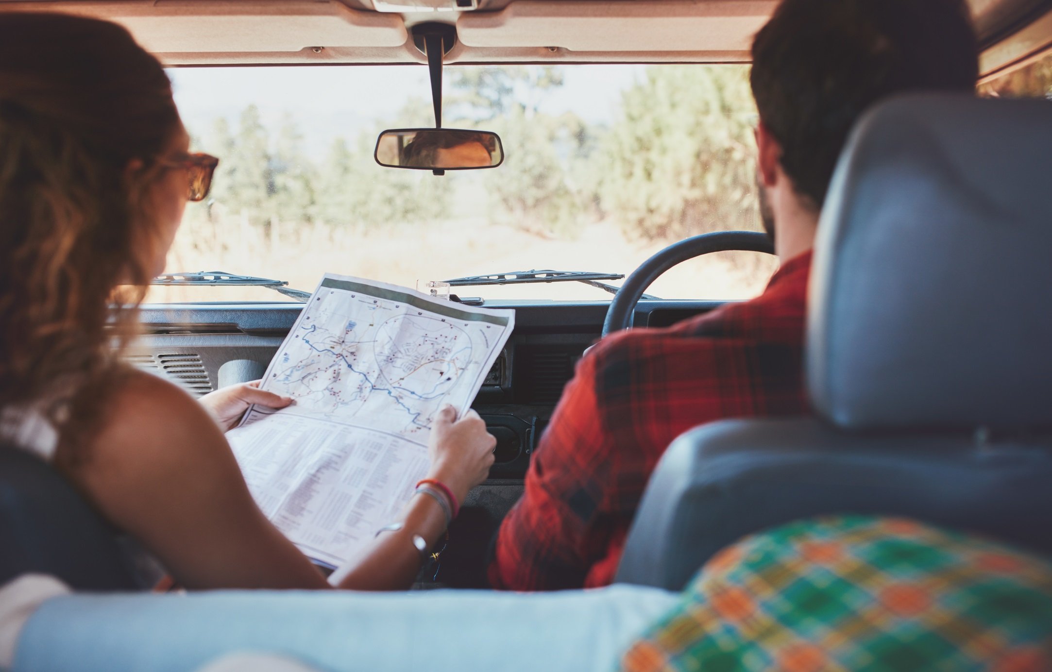 Couple driving on country road 2166x 1384