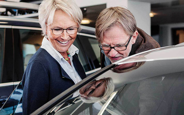 older couple with a car