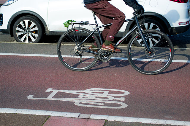 car driving alongside bike