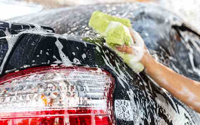 Car being washed with soap and sponge