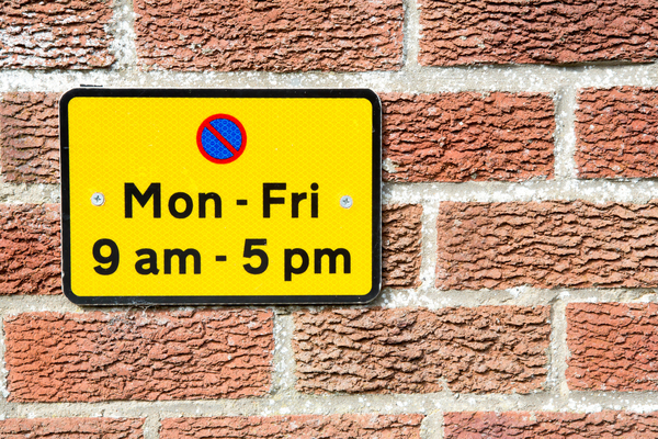 Brick wall and parking sign