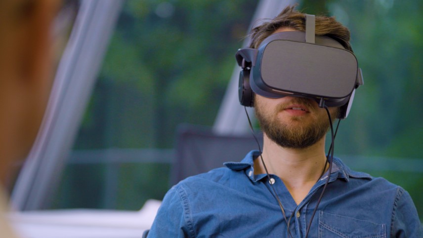 Trainee Driving instructor wearing a VR headset during training session in an office