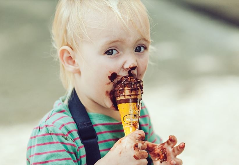 Child eating chocolate ice cream