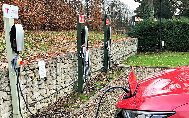 A Nissan Leaf charging at a Tesla charging point