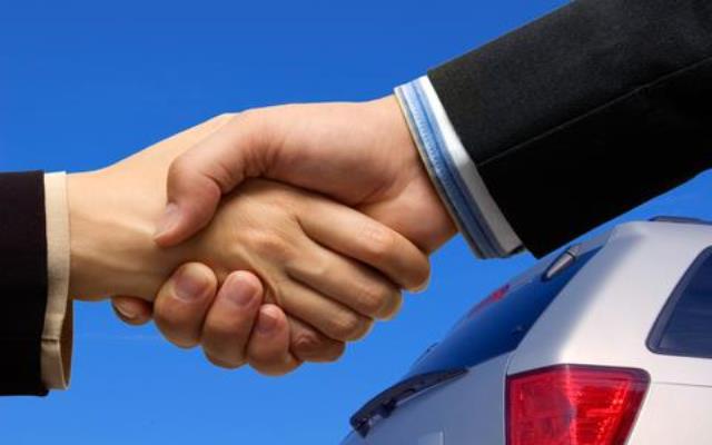 Shaking hands and car