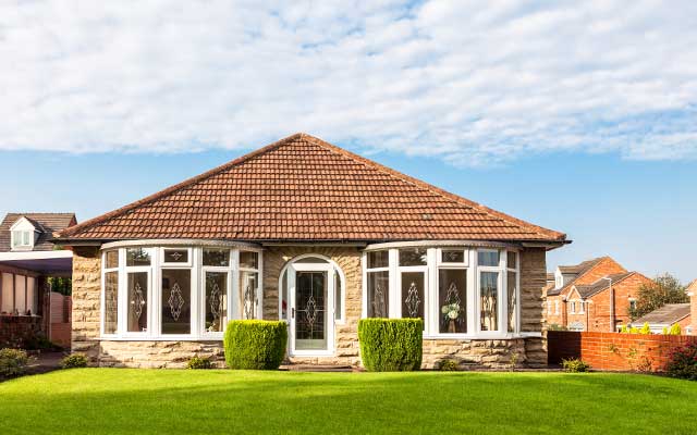 Front view of bungalow with green front garden