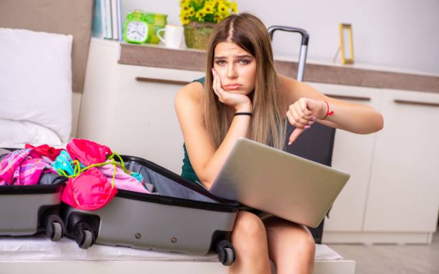 Young woman upset at having to cancel her holiday